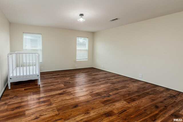 1104 E Lindell St, West Frankfort, IL 62896 - unfurnished bedroom featuring dark wood finished floors and baseboards