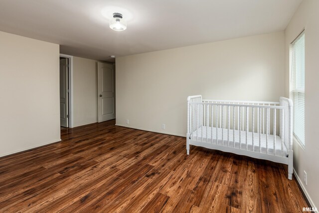 1104 E Lindell St, West Frankfort, IL 62896 - unfurnished bedroom featuring dark wood-style floors and baseboards