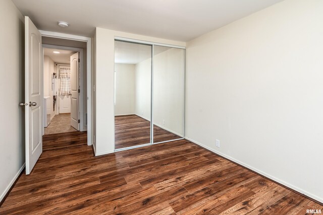 1104 E Lindell St, West Frankfort, IL 62896 - unfurnished bedroom with wood finished floors, a closet, and baseboards