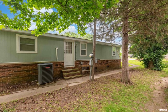 1104 E Lindell St, West Frankfort, IL 62896 - view of front of property with entry steps, central AC unit, brick siding, and crawl space