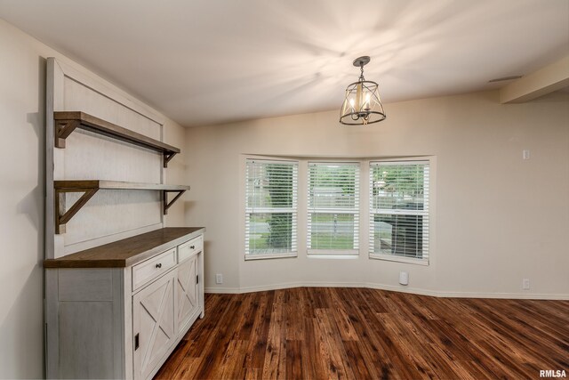 1104 E Lindell St, West Frankfort, IL 62896 - unfurnished dining area featuring dark wood-style floors, healthy amount of natural light, a chandelier, and baseboards