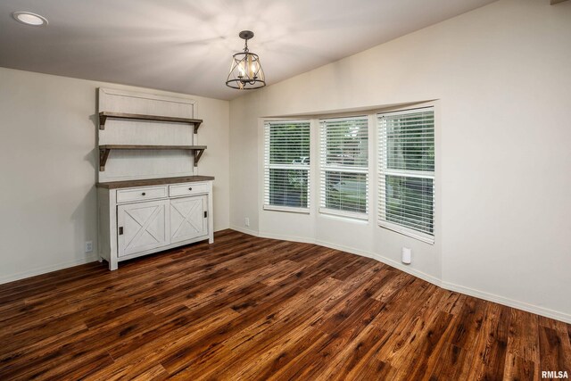1104 E Lindell St, West Frankfort, IL 62896 - unfurnished dining area with a chandelier, dark wood finished floors, baseboards, and vaulted ceiling