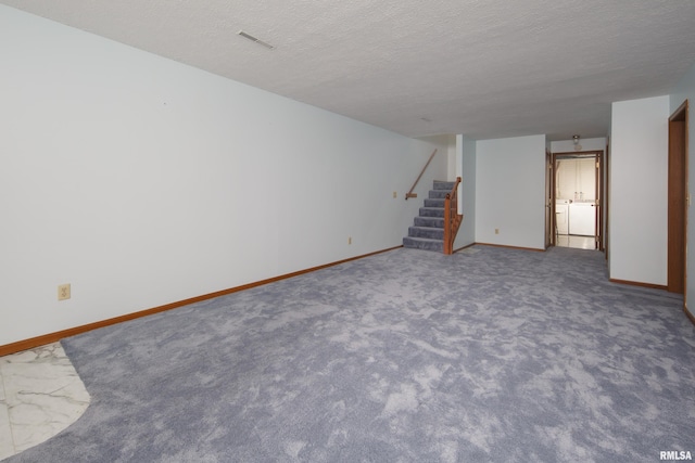 4675 Kynnelworth Dr Unit 301, Bettendorf, IA 52722 - finished below grade area with stairs, baseboards, washing machine and dryer, a textured ceiling, and carpet floors