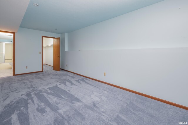 4675 Kynnelworth Dr Unit 301, Bettendorf, IA 52722 - unfurnished bedroom with baseboards, carpet, a walk in closet, and ensuite bathroom