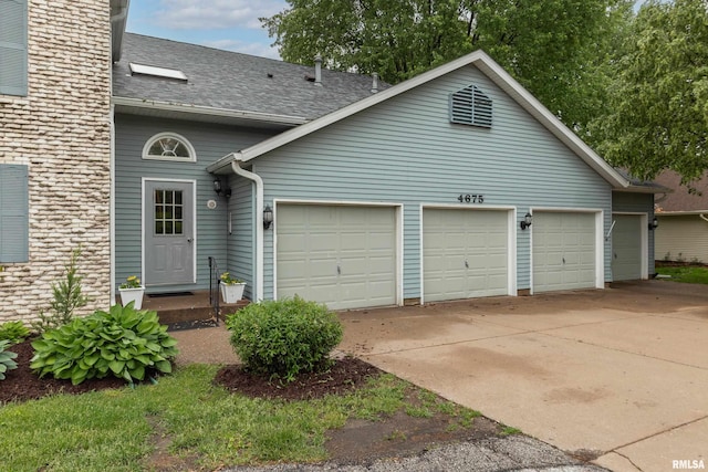 4675 Kynnelworth Dr Unit 301, Bettendorf, IA 52722 - view of front of house featuring driveway, a garage, and roof with shingles