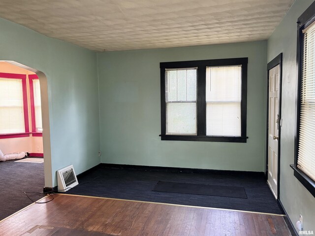 837 19th Ave, Moline, IL 61265 - empty room with arched walkways, plenty of natural light, and baseboards