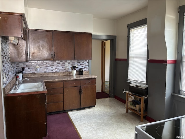 837 19th Ave, Moline, IL 61265 - kitchen featuring a sink, backsplash, dark brown cabinets, and light flooring