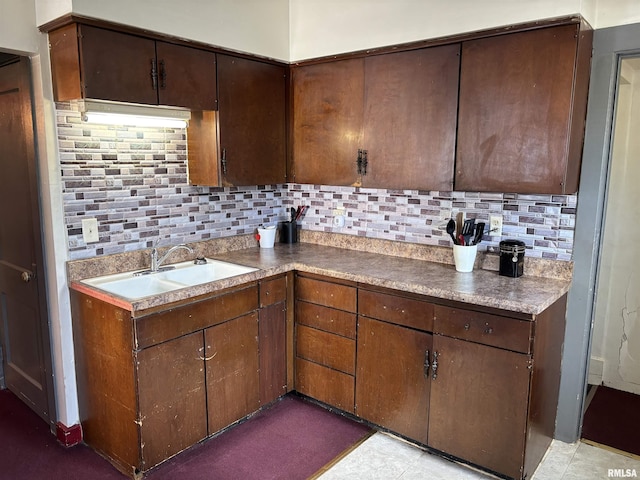 837 19th Ave, Moline, IL 61265 - kitchen featuring decorative backsplash, a sink, and dark brown cabinets