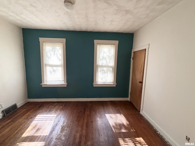 837 19th Ave, Moline, IL 61265 - unfurnished room with plenty of natural light, dark wood finished floors, and baseboards