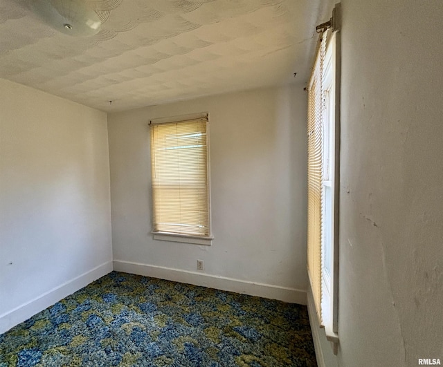 837 19th Ave, Moline, IL 61265 - empty room featuring baseboards and dark colored carpet
