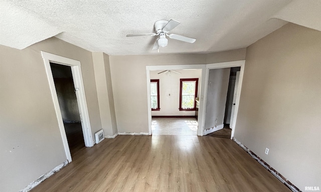 837 19th Ave, Moline, IL 61265 - empty room featuring a ceiling fan, wood finished floors, a textured ceiling, and baseboards