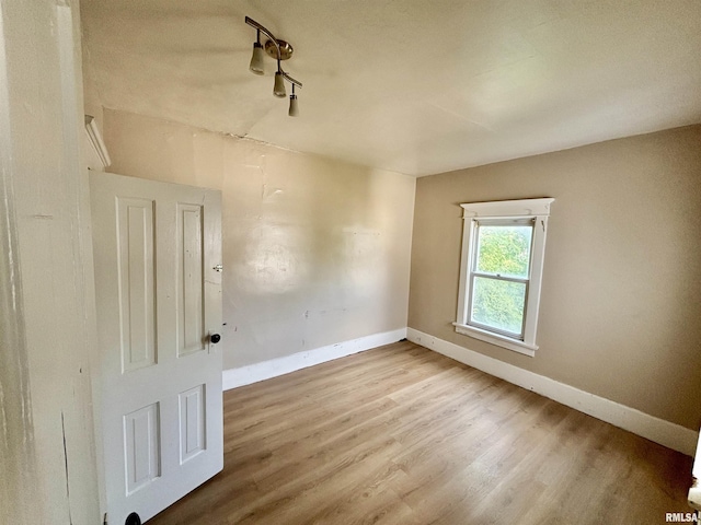 837 19th Ave, Moline, IL 61265 - spare room with wood finished floors, baseboards, and track lighting