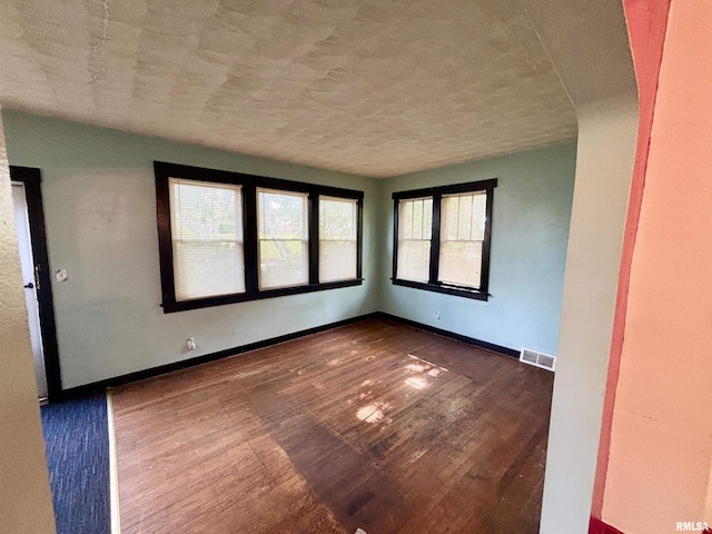 837 19th Ave, Moline, IL 61265 - spare room with dark wood finished floors, baseboards, and a textured ceiling