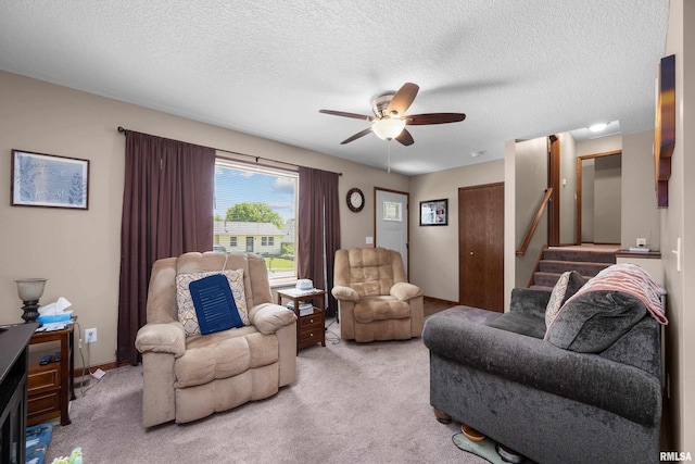 2614 W 59th St, Davenport, IA 52806 - living area with a ceiling fan, carpet floors, stairway, and a textured ceiling