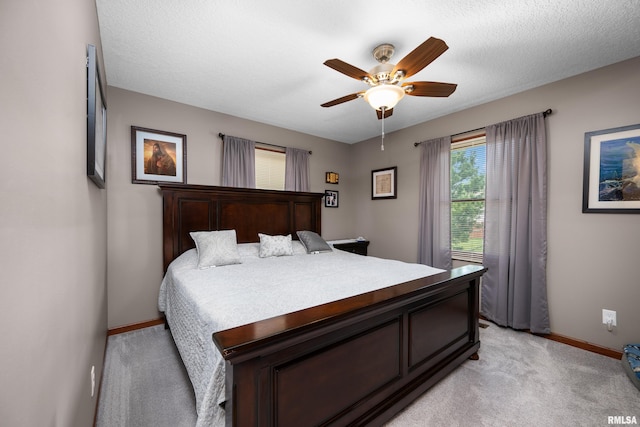 2614 W 59th St, Davenport, IA 52806 - bedroom with baseboards, light colored carpet, and a ceiling fan