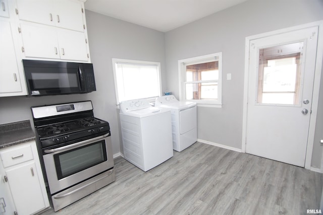 1502 N Ripley St, Davenport, IA 52803 - kitchen featuring black microwave, stainless steel range with gas stovetop, washer and dryer, light wood-type flooring, and white cabinetry