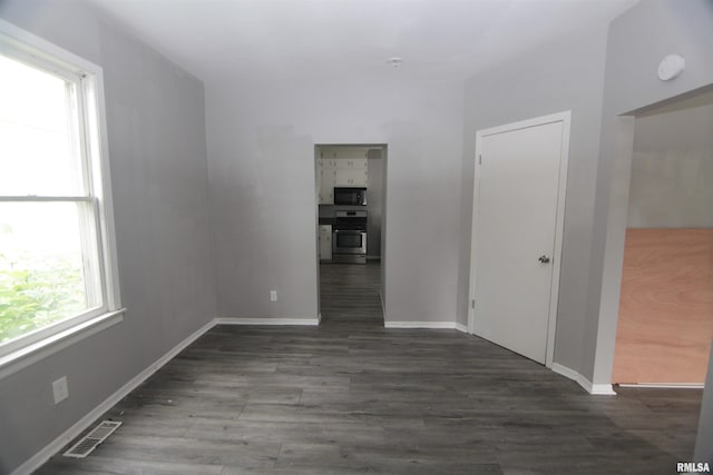 1502 N Ripley St, Davenport, IA 52803 - unfurnished room with wood finished floors, baseboards, and a smoke detector