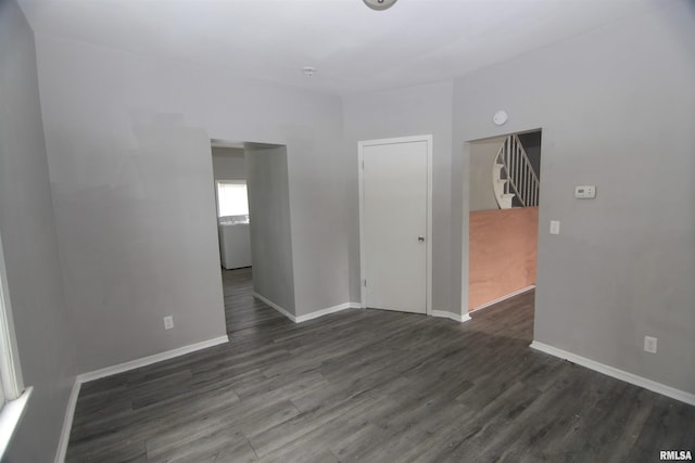1502 N Ripley St, Davenport, IA 52803 - empty room featuring dark wood-style floors, baseboards, and stairs