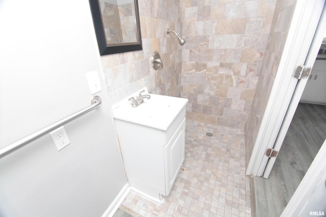1502 N Ripley St, Davenport, IA 52803 - bathroom with tiled shower, vanity, and tile walls