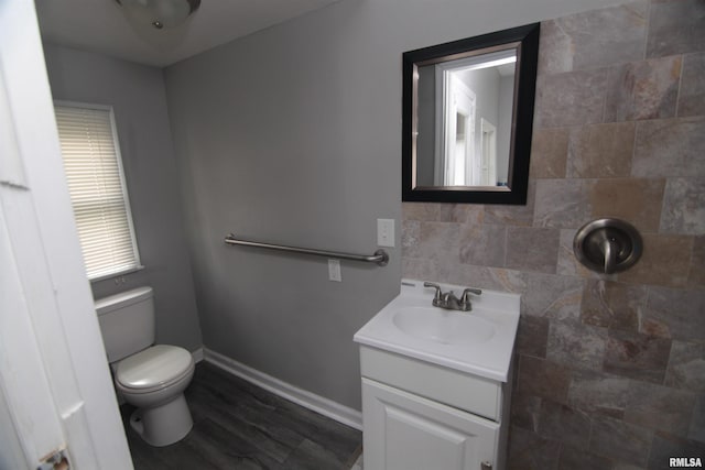 1502 N Ripley St, Davenport, IA 52803 - bathroom with vanity, toilet, wood finished floors, and baseboards