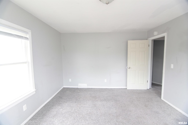 1502 N Ripley St, Davenport, IA 52803 - empty room featuring healthy amount of natural light, carpet floors, and baseboards