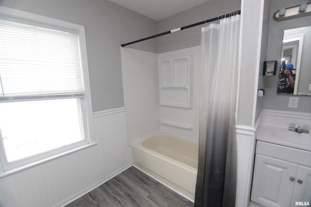1502 N Ripley St, Davenport, IA 52803 - full bathroom with vanity, wainscoting, shower / bathtub combination with curtain, and wood finished floors