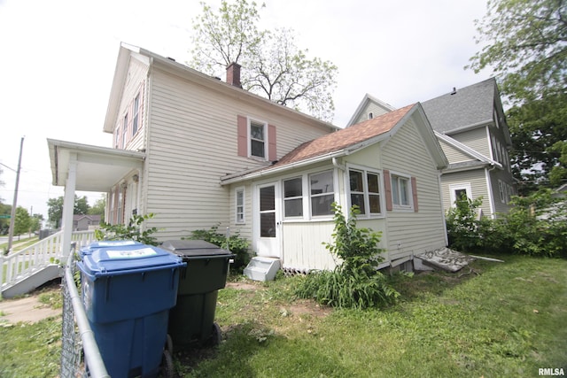 1502 N Ripley St, Davenport, IA 52803 - rear view of house with a chimney and a yard