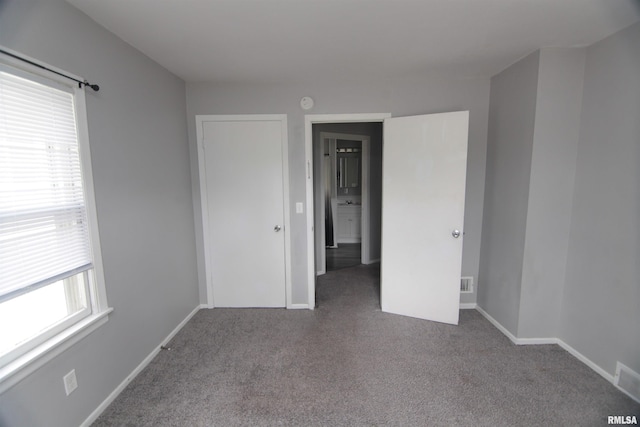 1502 N Ripley St, Davenport, IA 52803 - unfurnished bedroom with multiple windows, carpet, and baseboards