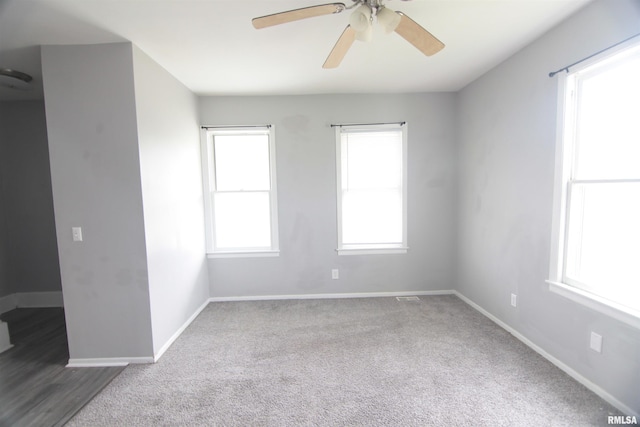 1502 N Ripley St, Davenport, IA 52803 - carpeted empty room with healthy amount of natural light, a ceiling fan, and baseboards