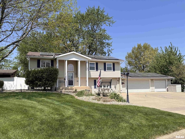 462 Circle Dr, Kewanee, IL 61443 - raised ranch featuring roof mounted solar panels, concrete driveway, and a garage