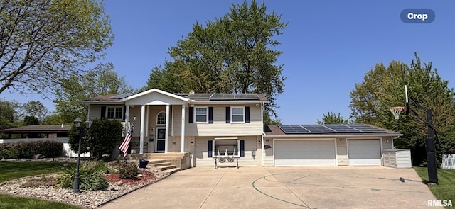 462 Circle Dr, Kewanee, IL 61443 - view of front of house featuring solar panels, an attached garage, and driveway