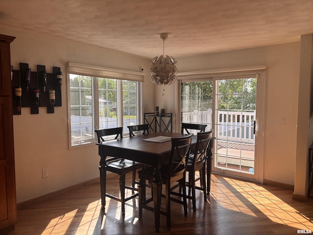 462 Circle Dr, Kewanee, IL 61443 - dining space featuring a chandelier, baseboards, and wood finished floors