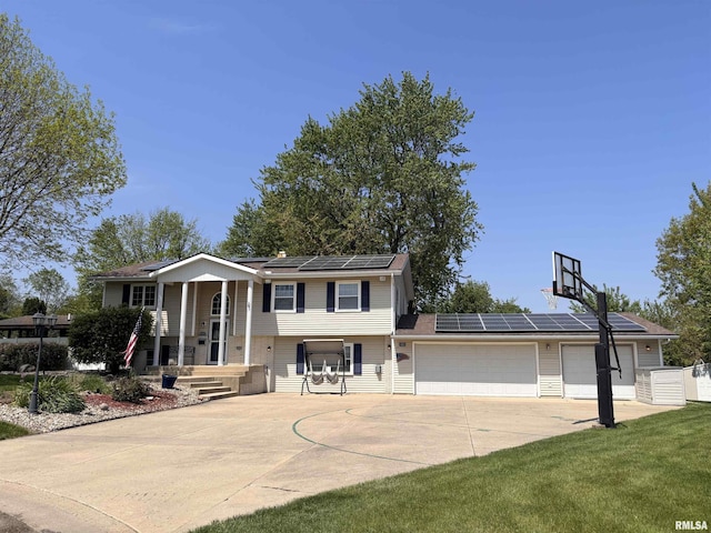462 Circle Dr, Kewanee, IL 61443 - split foyer home featuring solar panels, driveway, and an attached garage