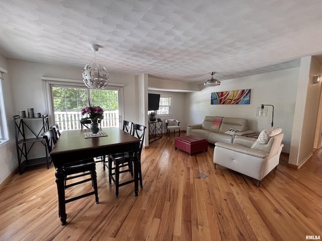 462 Circle Dr, Kewanee, IL 61443 - dining room featuring light wood-type flooring, a chandelier, and baseboards