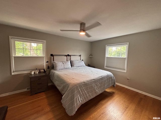 462 Circle Dr, Kewanee, IL 61443 - bedroom featuring multiple windows, baseboards, wood finished floors, and ceiling fan