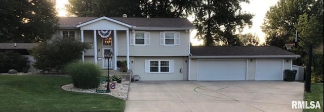 462 Circle Dr, Kewanee, IL 61443 - bi-level home featuring concrete driveway, a garage, and a front lawn