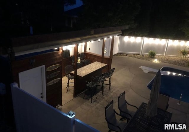 462 Circle Dr, Kewanee, IL 61443 - patio at night with a patio and a fenced backyard