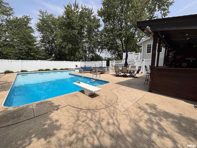462 Circle Dr, Kewanee, IL 61443 - view of pool with a patio, an outdoor living space, a fenced backyard, a diving board, and outdoor dining area