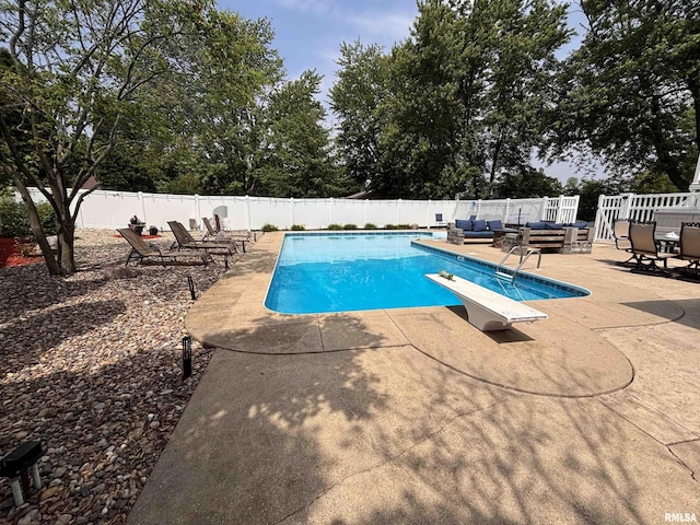 462 Circle Dr, Kewanee, IL 61443 - view of pool with an outdoor living space, a diving board, a patio, and a fenced backyard