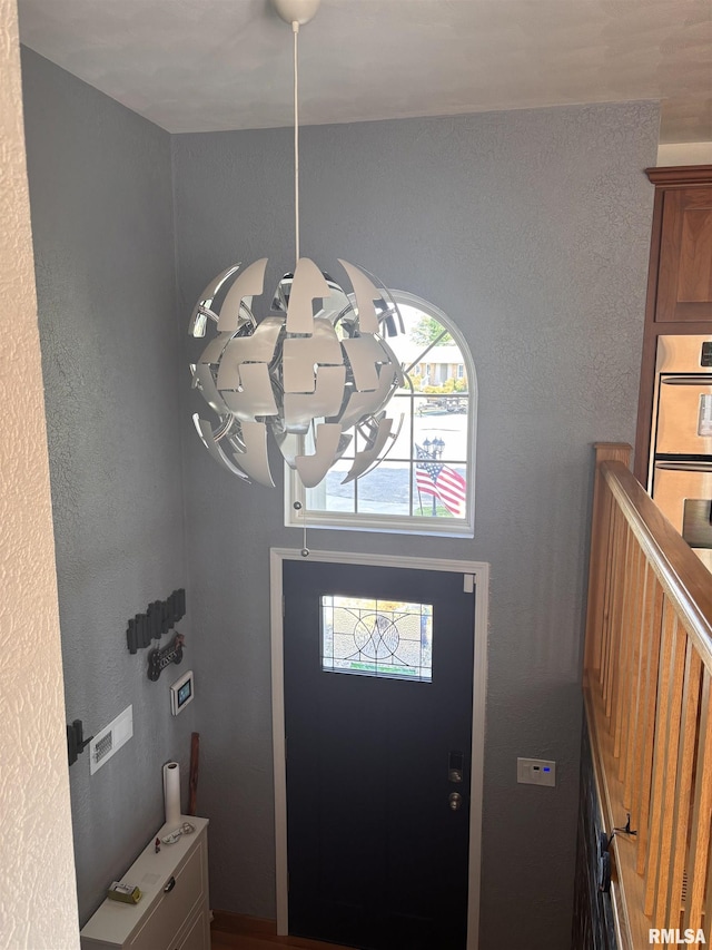 462 Circle Dr, Kewanee, IL 61443 - foyer entrance featuring a chandelier and a textured wall