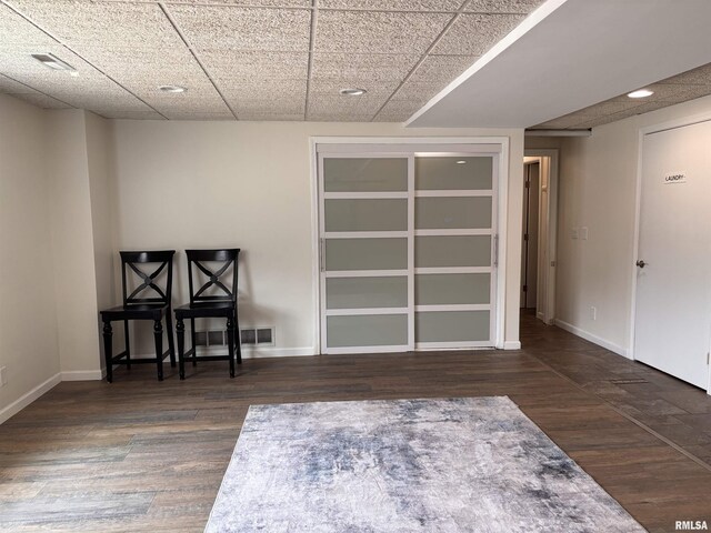462 Circle Dr, Kewanee, IL 61443 - unfurnished room with a drop ceiling, baseboards, and wood finished floors