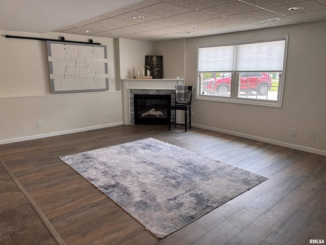 462 Circle Dr, Kewanee, IL 61443 - living area with wood finished floors, a fireplace, a barn door, and baseboards