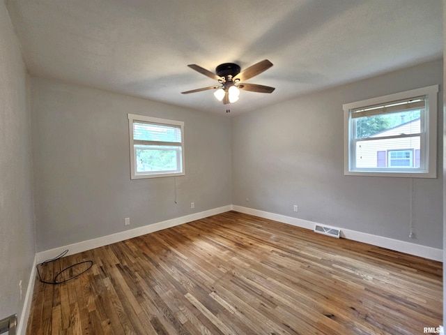 4325 N Lincoln Ave, Davenport, IA 52806 - empty room with healthy amount of natural light, wood-type flooring, baseboards, and ceiling fan