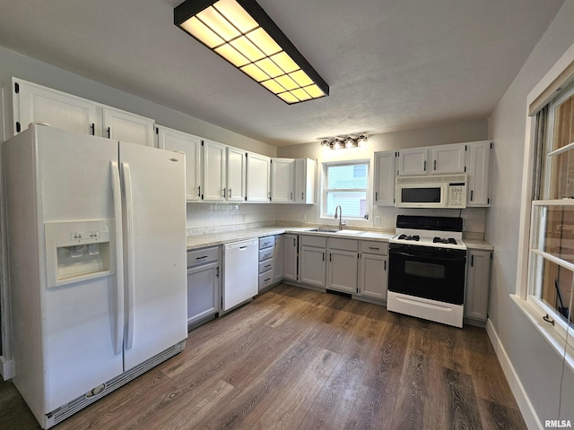 4325 N Lincoln Ave, Davenport, IA 52806 - kitchen featuring white appliances, a sink, dark wood-type flooring, and light countertops