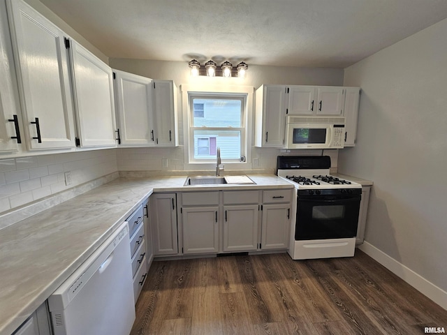 4325 N Lincoln Ave, Davenport, IA 52806 - kitchen featuring white appliances, a sink, dark wood-style flooring, tasteful backsplash, and white cabinetry