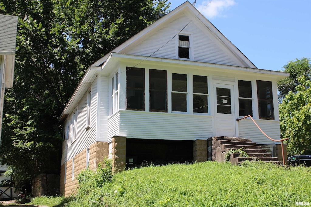 1309 Clay St, Davenport, IA 52804 - back of house with a sunroom and entry steps