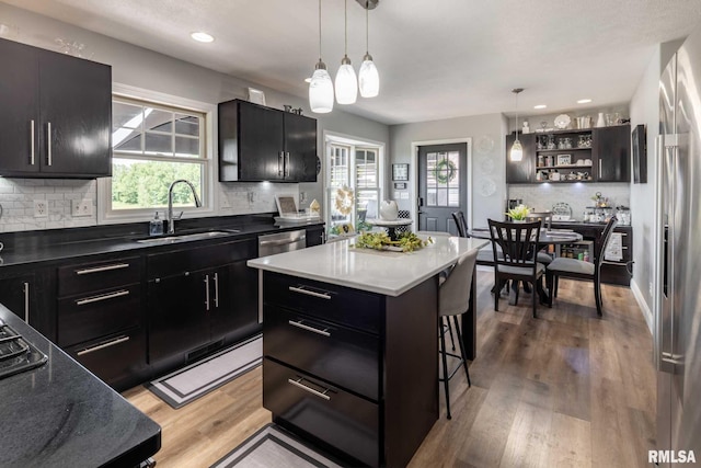 3160 Sycamore Rd, Carterville, IL 62918 - kitchen with a sink, dark cabinetry, a breakfast bar, hanging light fixtures, and recessed lighting