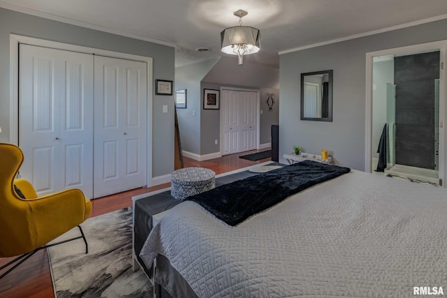 3160 Sycamore Rd, Carterville, IL 62918 - bedroom featuring two closets, wood finished floors, ornamental molding, baseboards, and ensuite bathroom