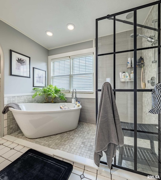 3160 Sycamore Rd, Carterville, IL 62918 - bathroom featuring walk in shower, tile walls, a freestanding tub, recessed lighting, and wainscoting