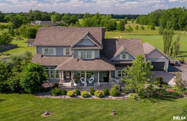 3160 Sycamore Rd, Carterville, IL 62918 - view of front of home featuring a front lawn, covered porch, a garage, a shingled roof, and asphalt driveway